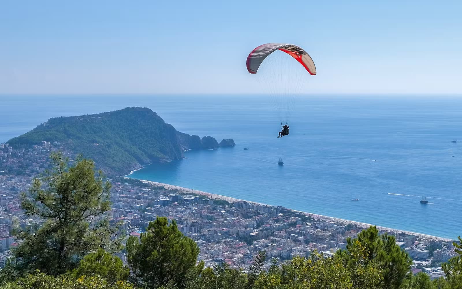Paraglider above Alanya Castle peninsula and Cleopatra Bay
